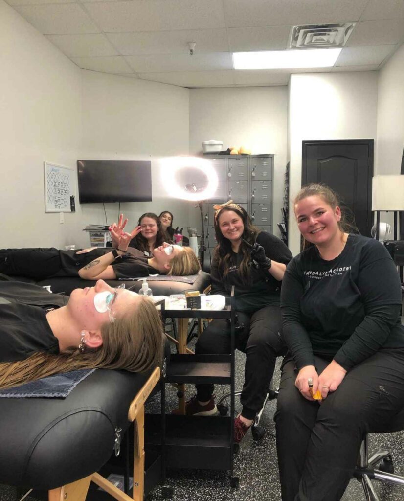 Young Female Getting Cosmetic treatment in cosmetic clinic resting on a Beds and some students smiling | Mandalyn Academy in American Fork, UT