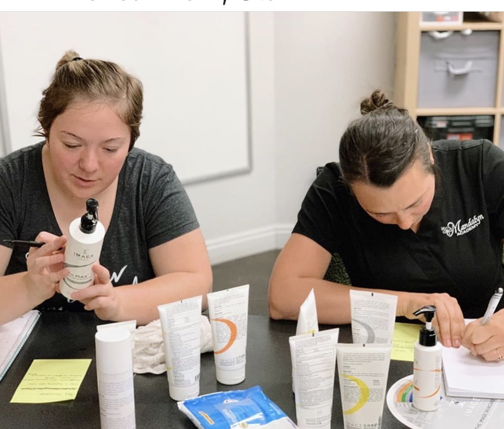 Team member checking skincare product | Mandalyn Academy in American Fork, UT