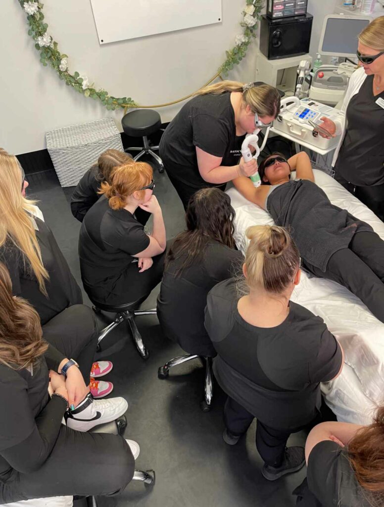 Blonde woman having underarm Laser hair removal epilation Laser treatment in cosmetic salon and students watching this | Mandalyn Academy in American Fork, UT